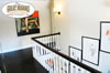 Second floor hallway with stair rail and dark hardwood floor