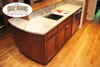 Kitchen with oak floor and marble countertops