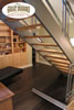 Steel stairway with light hardwood treads and dark wood floor at landing