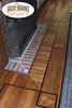 Interesting geometric pattern around fireplace created by inlaying different woods into hardwood floor
